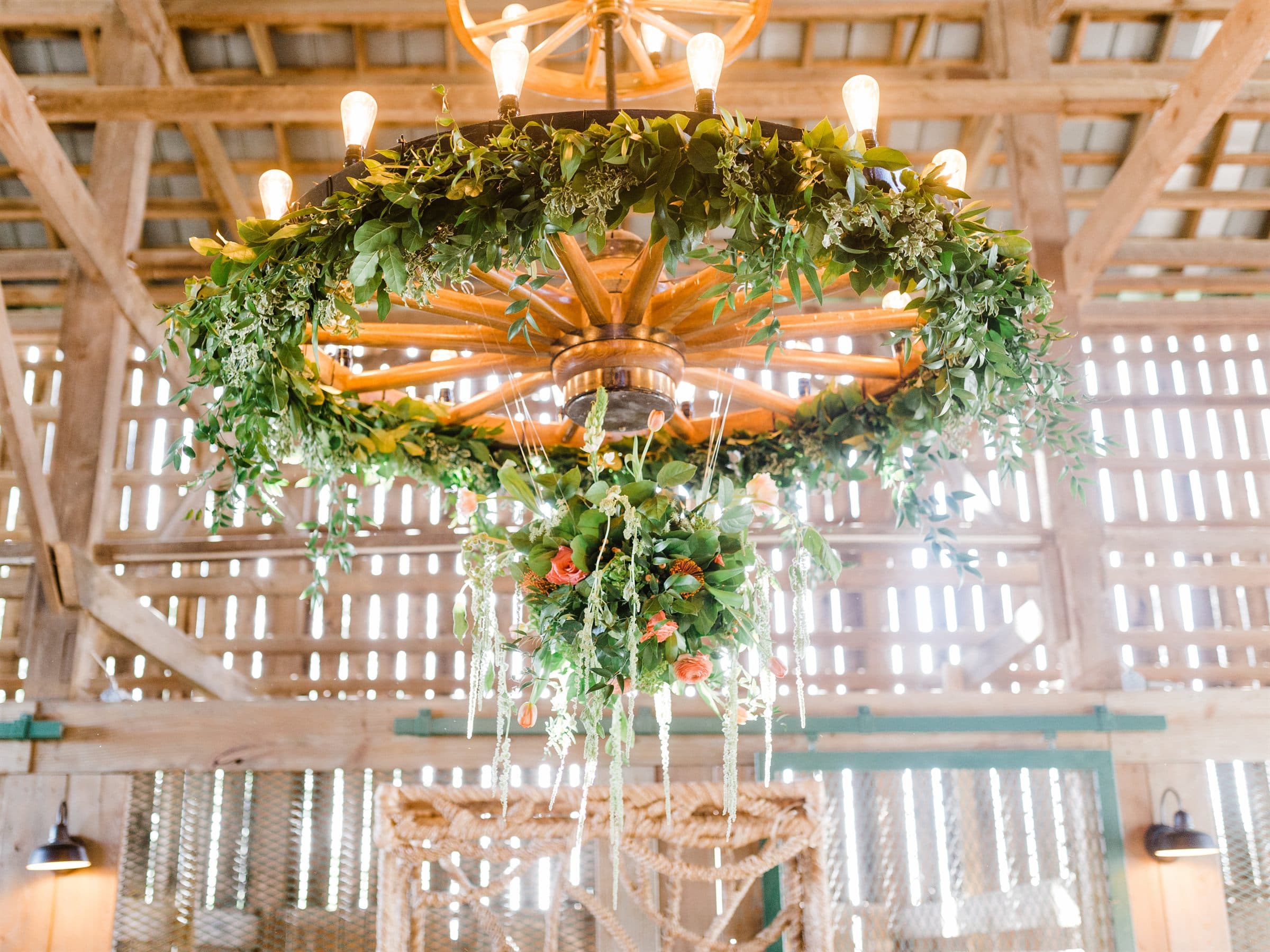 A greenery chandelier hung in the barn loft