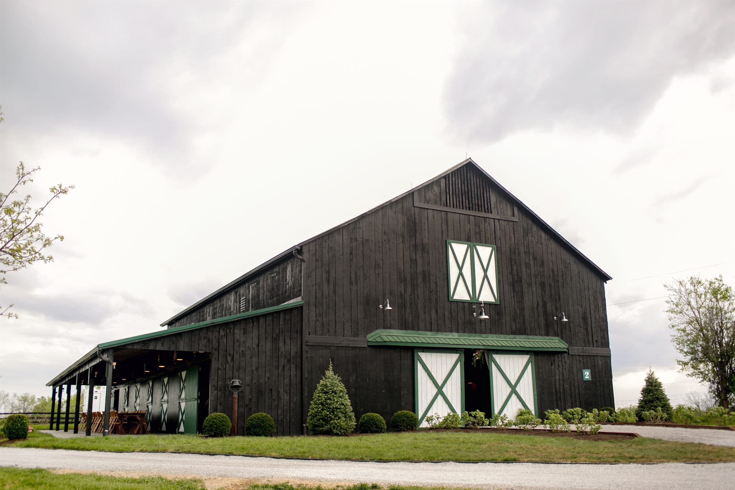 The black barn under a dramatic Kentucky sky