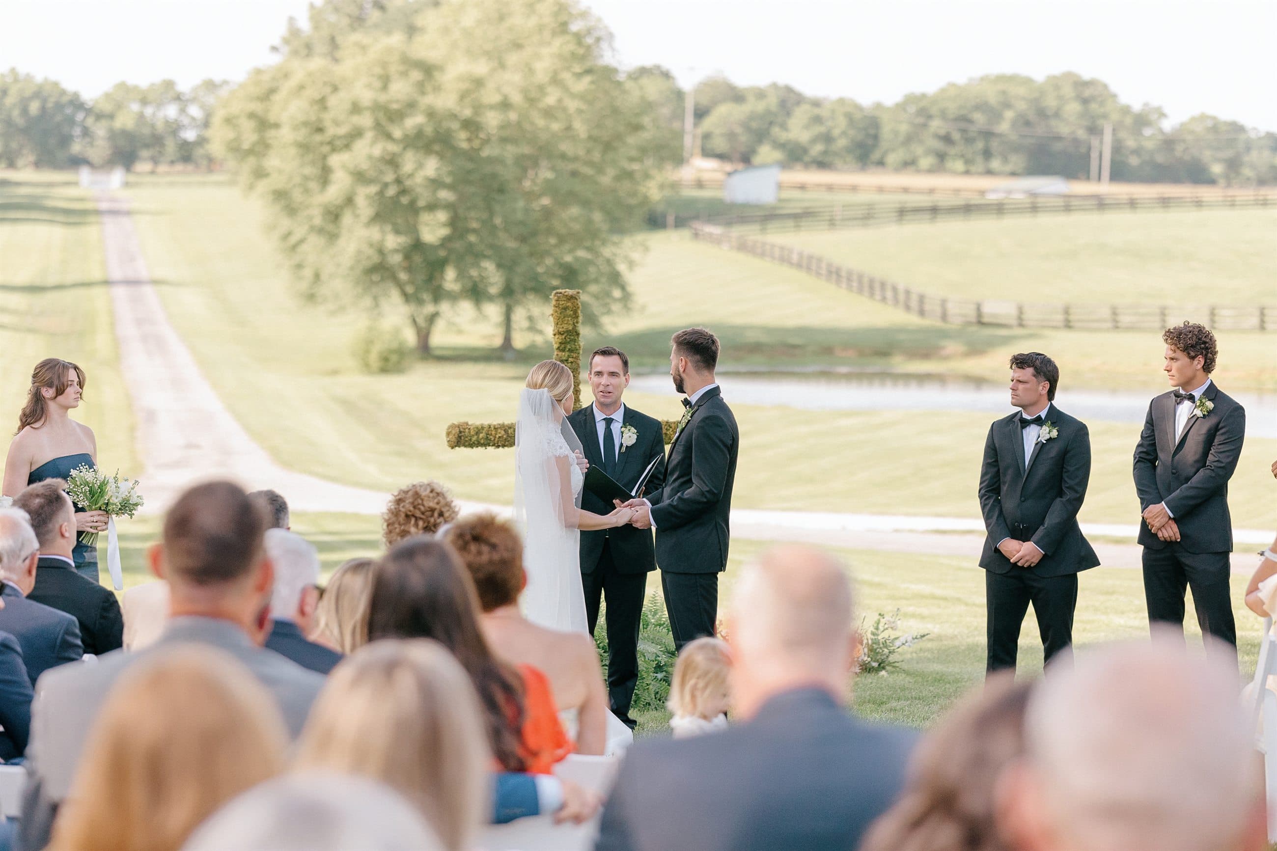 A ceremony on the lawn with the bluegrass rolling out behind it