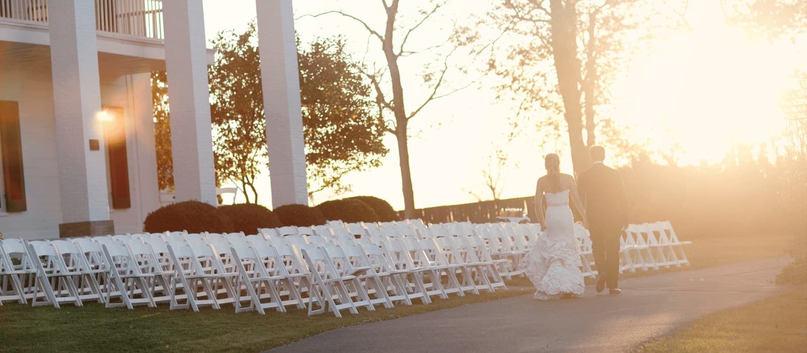 Ceremony chairs before the manor at golden hour