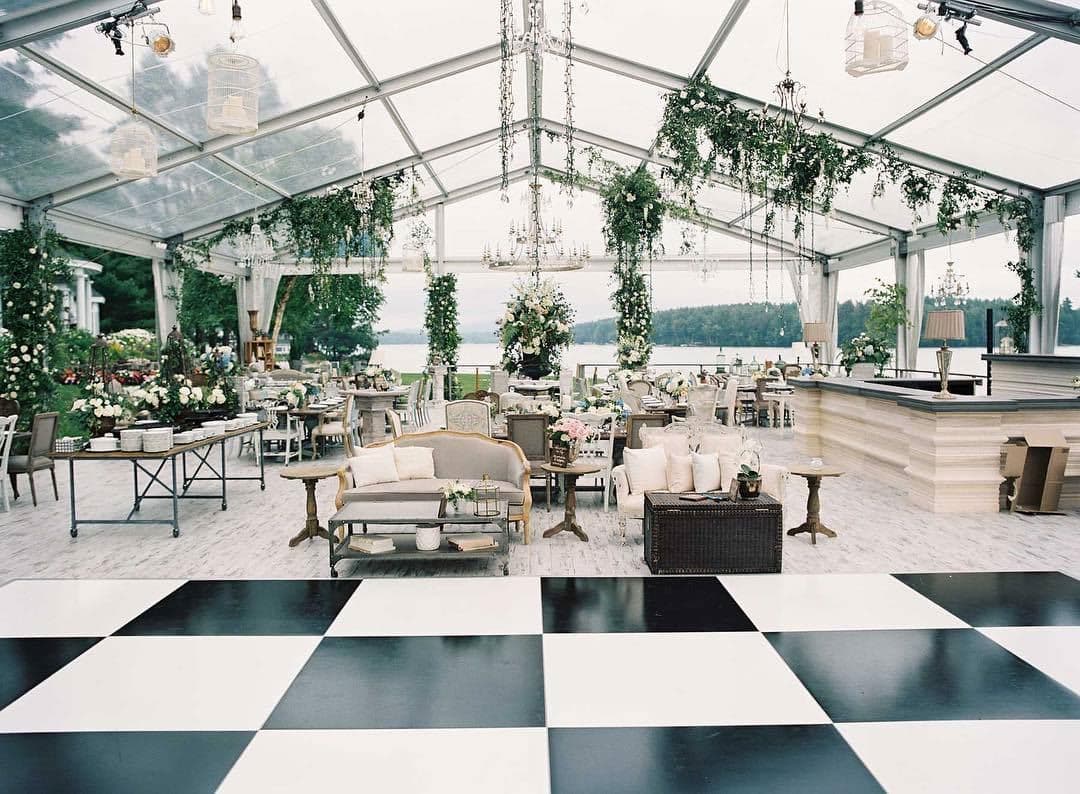 A clear-top tent with a checkered dance floor