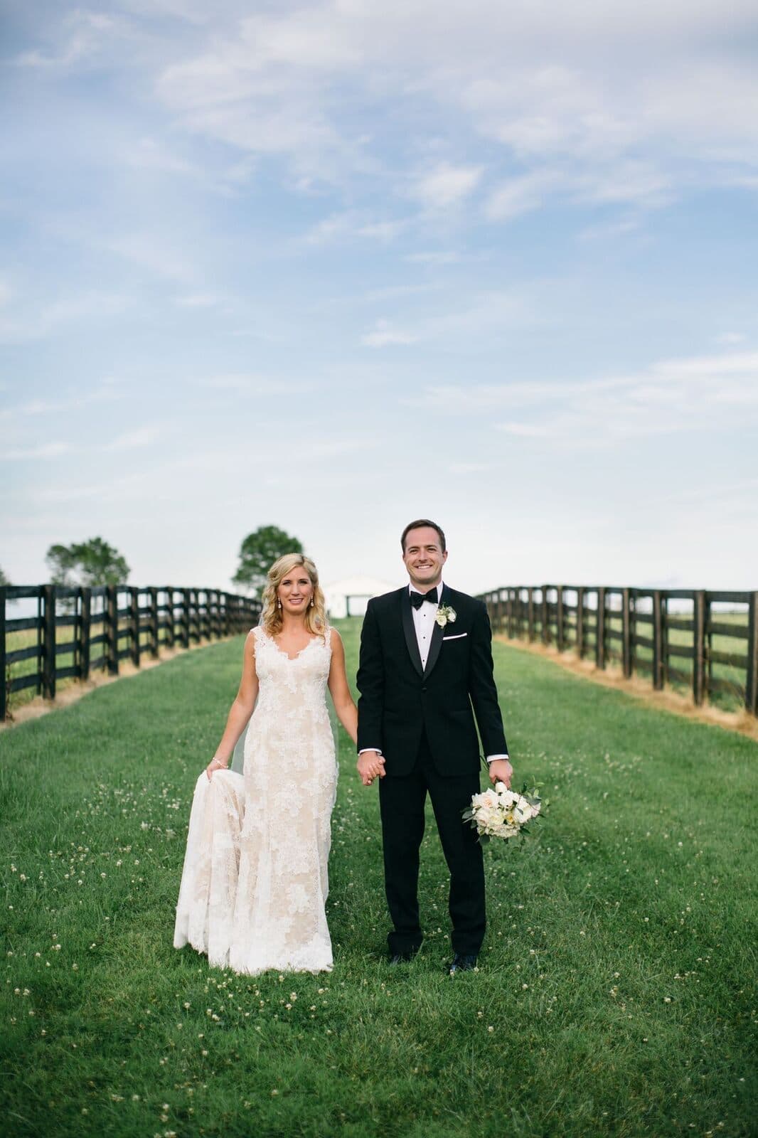 A couple walking the fence-lined lane