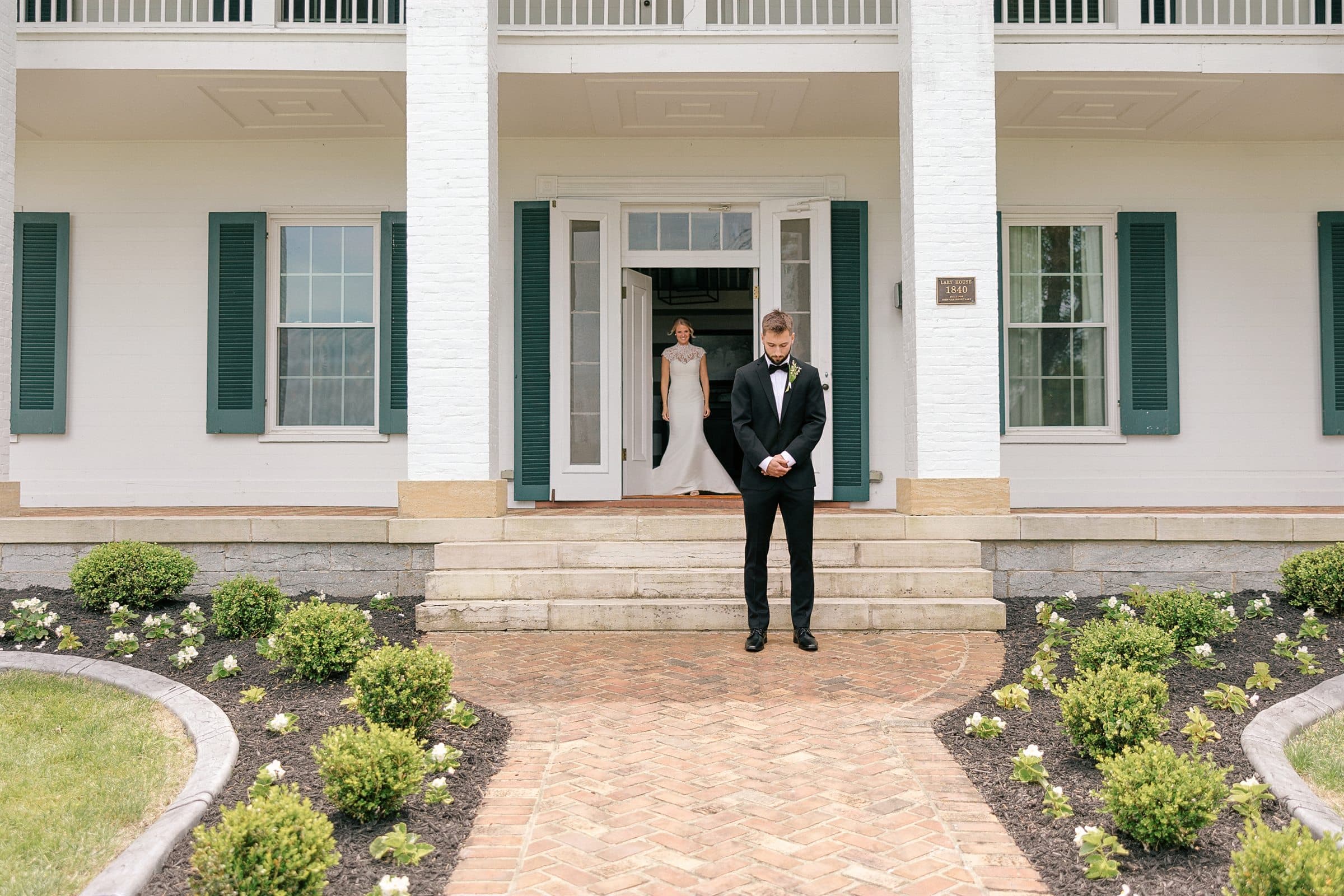 The groom waiting at the manor door