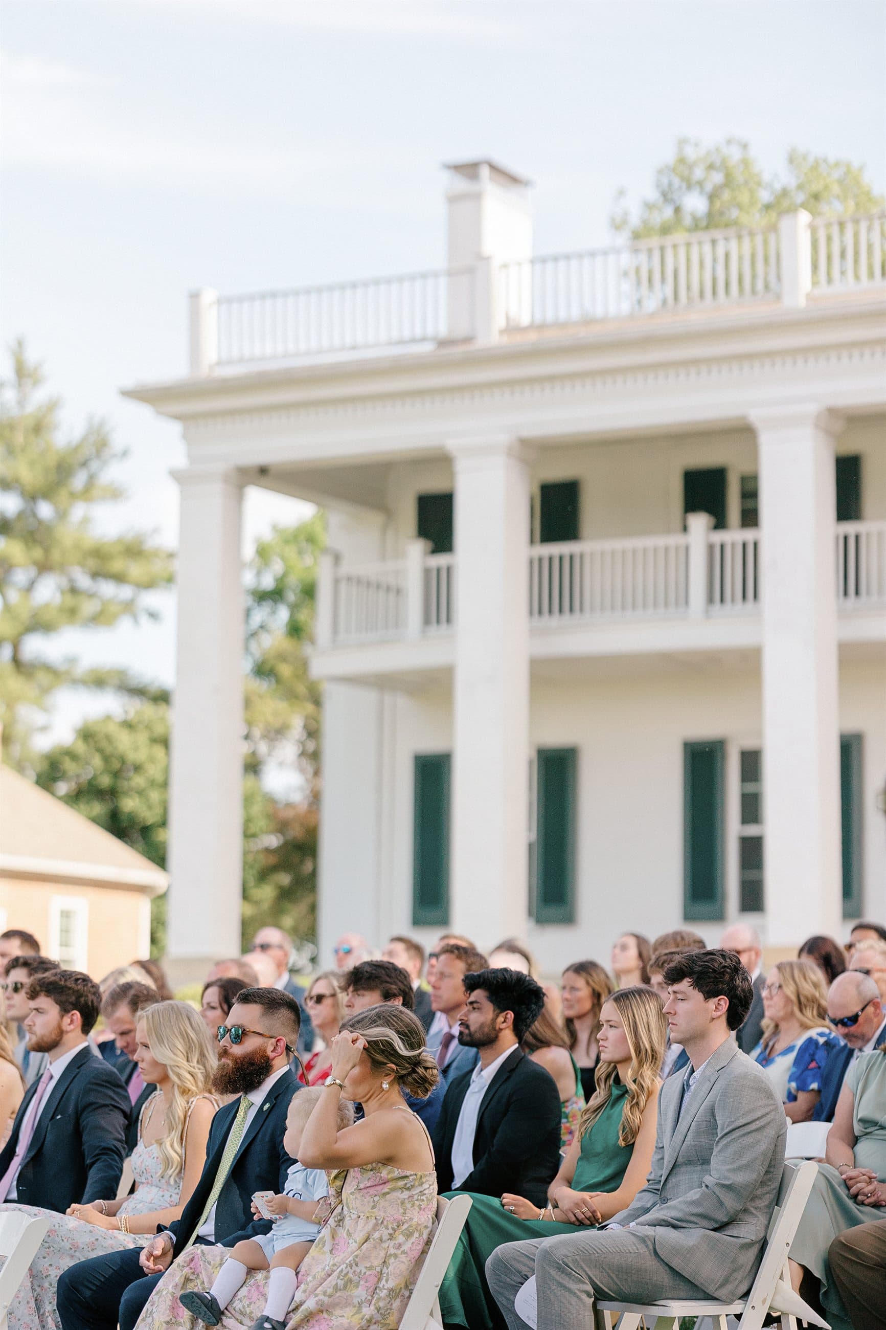 Guests seated before the manor